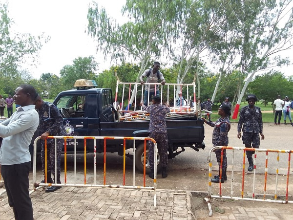 Security officers offloading barricades from a truck