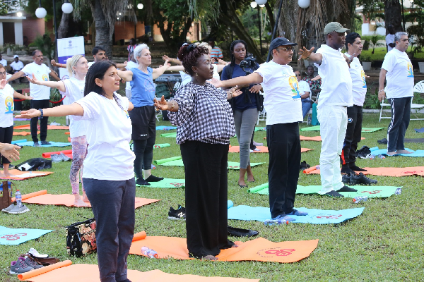 Dzifa Gomashie (2nd from L front row) and Kofi Adams (4th from L) at the yoga event with the Indians