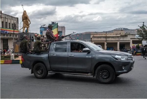 Members of the Amhara militia ride in the back of a truck in the city of Gondar, Ethiopia