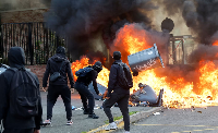 Students burn garbage as they protest to demand more resources at school, in Lille, France