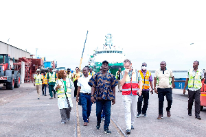 Dr Dogbey (in smock) and some officials during his visit to some cocoa takeover centers