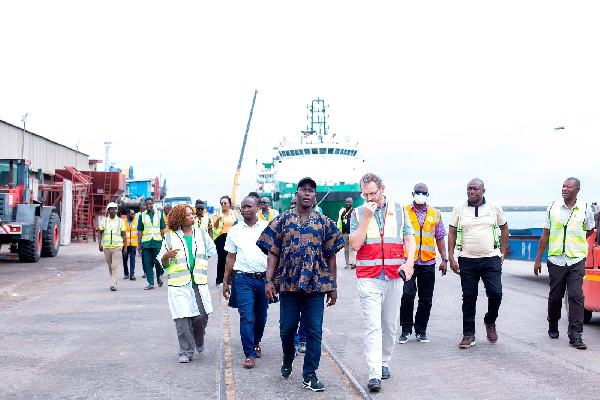 Dr Dogbey (in smock) with some officials during his visit to some cocoa takeover centers