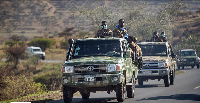 Ethiopian government soldiers travel in the back of trucks on a road near Agula, north of Mekele