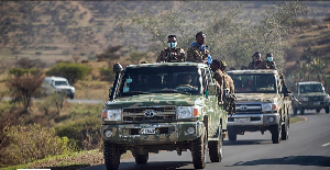 Ethiopian government soldiers travel in the back of trucks on a road near Agula, north of Mekele