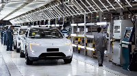 Workers busy at a production line of an electric vehicle