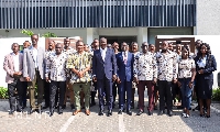 Abu Jinapor with his deputy in a group photo with management and staff of MDF