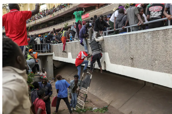 Supporters of Kenyan opposition leader Raila Odinga run for cover after shots were fired