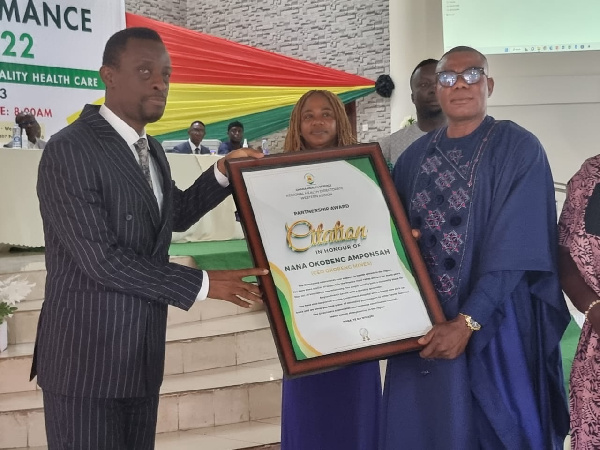 Nana Okoben receiving his award from the Western Regional Minister