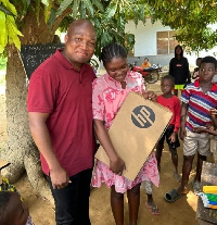 Samuel Okudzeto Ablakwa presented a brand new laptop to Gertrude Nutsukpui,