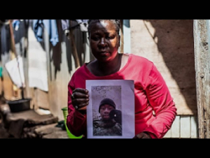 A mother holds a photo of her son, David Shitanda, in Kibera A mother holds a photo of her son, David Shitanda, in Kibera