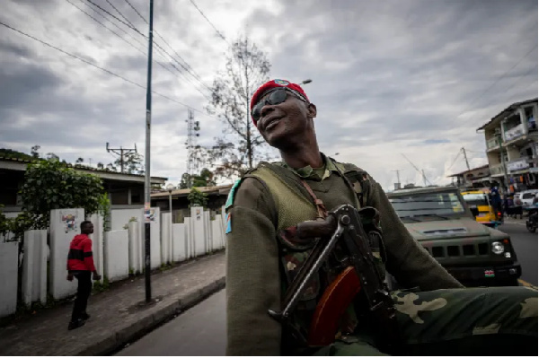 A DRC soldier escorting peacekeepers with the East African Community Regional Force