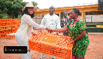 Ewurabena Aubynn presenting some of the items to some community members