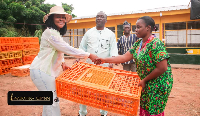 Ewurabena Aubynn presenting some of the items to some community members