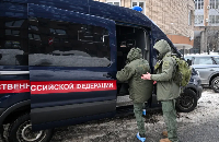 Investigators leave the scene of an assassination attempt on Russian Lt\ General Vladimir Alekseyev