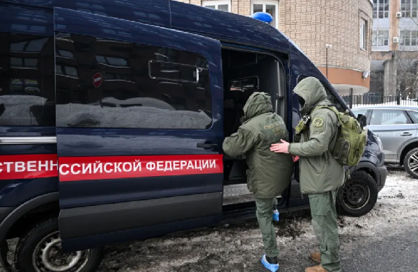 Investigators leave the scene of an assassination attempt on Russian Lt\ General Vladimir Alekseyev