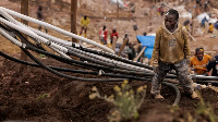 A young labourer arranges oxygen cables for installation in a new shaft at the Rubaya coltan mine