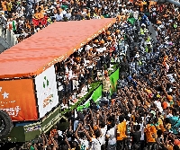 Photo of packed street as the winning team drives through principal streets of Abidjan