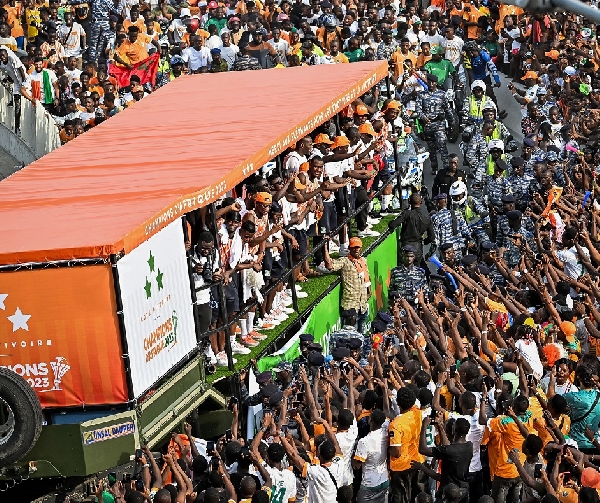 Photo of packed street as the winning team drives through principal streets of Abidjan