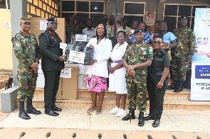 Colonel Eric Aboagye Tieku, presenting the items to some medical officials of Duala Medical centre