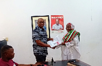 Hajia Hawa Tahiru (right) handing over her forms to the NDC Volta Regional Director of Elections