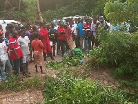 A group of people at the scene of an accident
