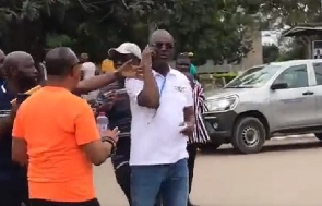 Kennedy Agyapong, Assin Central MP in white speaking in a phone call