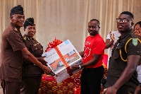 Kwasi Barfi Vivo Energy's Asset Intergirty Manager (clad in red) presenting the items to authority