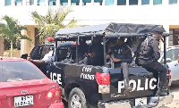 A police vehicle transporting the suspects following their remand into prison custody