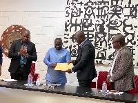 GJA President Albert Dwumfour (in blue) receives the donation