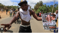 A protester holds up a sign during protest against the establishment of a Ebola quarantine center