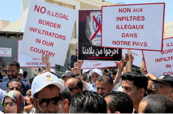 Libyans demonstrate in front of the UNHCR office in Tripoli