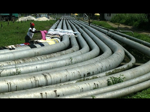 Woman dries clothes on an oil pipeline in Port Harcourt Woman dries clothes on an oil pipeline in Port Harcourt