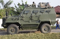 An armoured personnel carrier is seen outside a school in Mpondwe that was attacked in June