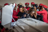 Susan Njeri, (C), mother of Boniface  is supported by youth and family members after seeing his body