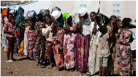 People who fled the conflict in the Tigray region in Northern Ethiopia wait to receive food in Hamda