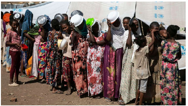 People who fled the conflict in the Tigray region in Northern Ethiopia wait to receive food in Hamda