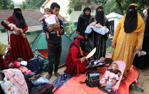 Rohingya refugees gather in front of the office of the UN Refugee Agency (UNHCR)