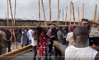 Some affected traders offloading wood from a truck