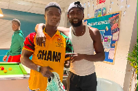 Hayford Addae (L) receiving the spikes from Joseph Paul Amoah (R)