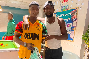 Hayford Addae (L) receiving the spikes from Joseph Paul Amoah (R)