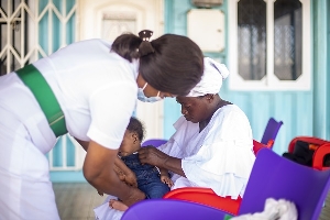 A photo of a nurse attending to a child