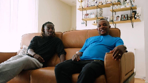 Jeremy Doku (L) and his dad
