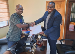 Nathaniel Nana Kwabena Nkrumah and Kofi Adu Domfeh  are exchanging pleasant hand shakes