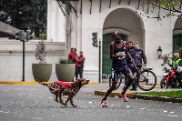 Robert Kimutai Ngeno chased by a dog