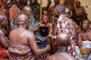 A rep presenting a watch to Otumfuo Osei Tutu II