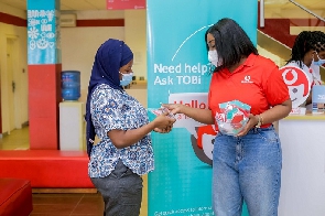 Angela Mansah Poku introduces TOBi to a Vodafone customer