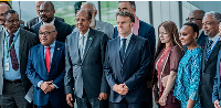 French President Emmanuel Macron poses with delegates at the African Union headquarters