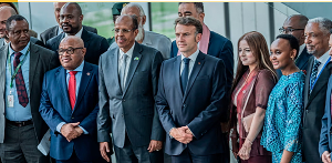 French President Emmanuel Macron poses with delegates at the African Union headquarters