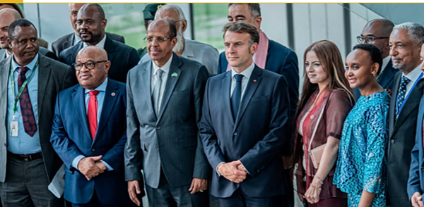 French President Emmanuel Macron poses with delegates at the African Union headquarters