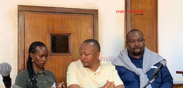 Fraud suspects Eve Gershom, Bob Tumwebaze (C) and Tanzanian Eric Lugeleka dock at Buganda Road Court